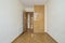 Empty bedroom with plain white painted wall, herringbone oak parquet