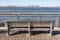 Empty Bench along a St. George Waterfront Park in Staten Island of New York City with a view of the Lower Manhattan Skyline