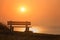 Empty bench with amazing sunrise sea view, peace and calm romantic travel background