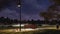 Empty bench in city park at dark autumn night