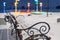 An empty bench covered with snow in winter goes out of focus