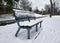 Empty bench covered with snow in wintertime