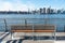 Empty Bench at a Park in Greenpoint Brooklyn New York looking out towards the East River and the Manhattan Skyline