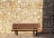 An empty bench, stone blocks background
