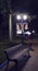 Empty bench under lantern in evening park. Night lights illuminate the path