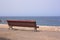 An empty bench where to sit in front of the sea