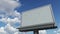 Empty billboard against cloudy sky. Time lapse