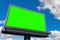 Empty billboard with chroma key green screen, on blue sky with c