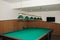 Empty billiard table with lamps above it. Sports and indoor games free time concept