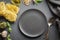 Empty black plate and border of raw pasta, pesto, basil, parmesan for cooking Mediterranean dishes