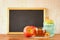 Empty blackboard, apple, honey and pomegranate. rosh hshanah concept