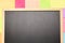 Empty blackboard and coloured post-it on it