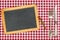 Empty blackboard with silverware on a tablecloth