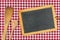 Empty blackboard with wooden spoons