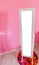 Empty blank mirror standing in a little princess girls room with pink wall background and space to drop what ever you want