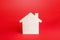 Empty blank wooden house on red background. Buying and selling real estate. Housing, realtor services. Renovation and home