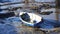 Empty blue fishing rowboat on a sandy shore in Portsmouth, UK