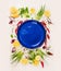 Empty blue plate with fresh seasoning and spices on withe rustical wooden background, top view