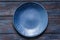 Empty blue plate on old rustic wooden table