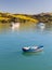 Empty blue rowing boat Akaroa Harbor