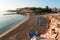 Empty blue sunbeds are on sandy beach of Protaras resort at morning. Cyprus island