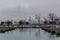 Empty boat docks on calm lake with the Chicago skyline in the distance