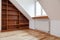 Empty bookshelf in the attic