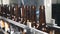 Empty bottles stand in row on a technological line at beer factory. Bottles Moving on Conveyor Belt at Glass Bottle