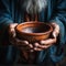 Empty bowl held by elderly hands, symbolizing the stark reality of hunger