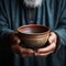Empty bowl held by elderly hands, symbolizing the stark reality of hunger