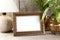 Empty brass picture frame on wooden background.