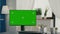 Empty bright living room with isolated mock-up green screen chroma key monitor