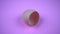 Empty broken brown egg shell on purple color background