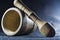 Empty brown mortar with a pestle wooden. A drinking bowl for crushing of spices. Black background. Kitchen utensils. Ware.