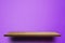 Empty brown wooden shelf on Purple Cement wall