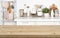 Empty brown wooden table with blurred image of kitchen interior