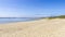 Empty calm white sand beach under the clear blue sky