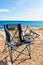 Empty camp chair and bicycle on beach