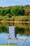 Empty camp chair on lake shore