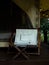 Empty camping wooden chair with white fabric seat and footrest on the terrace in front of the room.