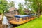 Empty canal cruise boat in front of old houses in the village of Giethoorn