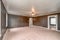 Empty carpeted living room with dark walls white front door and lots of windows