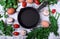 Empty cast iron pan. Chicken eggs, vegetables, greenery and mushrooms around