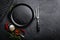 Empty cast-iron pan with ingredients for cooking on black background