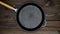 An empty cast iron skillet on a wooden table. Frying pan ready for cooking. Copy space for text and adv. Blank Space. Copy