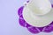 Empty ceramic cup and saucer on violet coaster