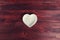 Empty ceramic saucer in the form of heart on a dark wooden table