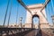 Empty Chain Bridge in Budapest is a historical architecture, famous for tourism, without any transport, with a kings emblem, natio