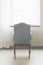 Empty chair in front of a brightly lit window in a hospital