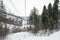 Empty chair ski lift on the gloomy mountains. Winter time.